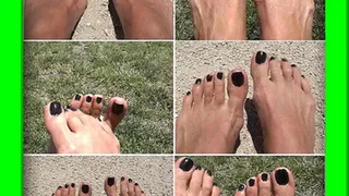 Dark painted toes in grass and sand