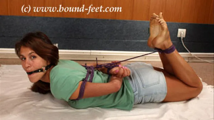 Roxana in t-shirt and short shorts hogtied barefoot on the floor and ball-gagged, then get foot massage, tickling and teasing