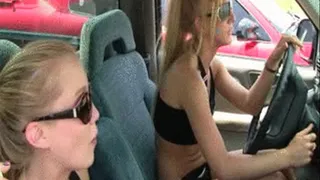 two sexy girls goofing around in a pickup truck