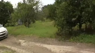 Two girls stuck in car on soft dirt