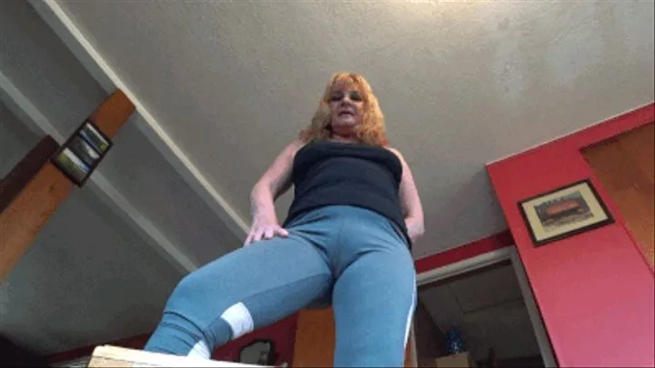 Giantess lady in yoga pants sits and stomps on little tiny man with her bare foot