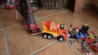 Red sandals on white spiked heels crushed concrete mixer truck.
