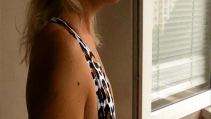 Smoking in leopard swimsuit on balcony