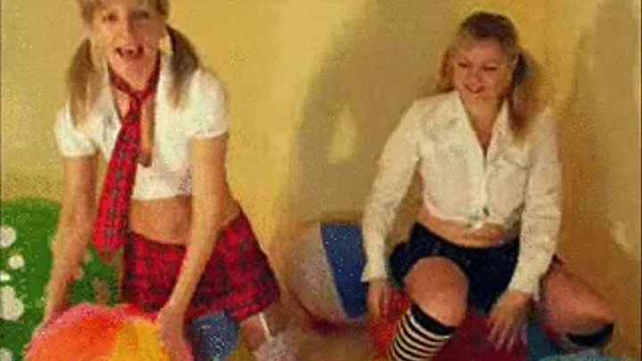 2 Schoolgirls riding beachballs -LQ