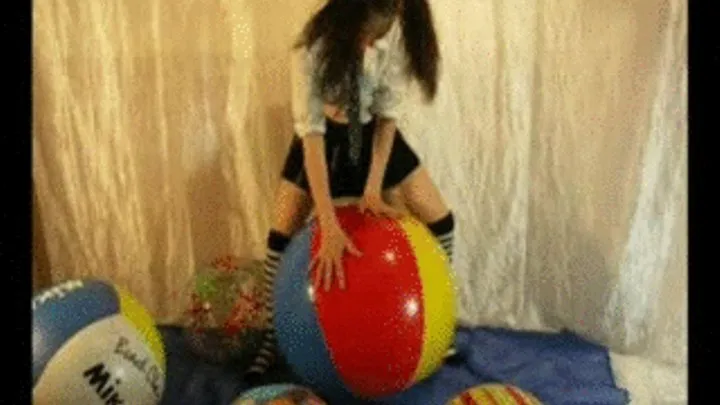 Schoolgirl Jackie rides beachball