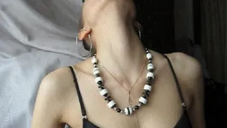 BLACK-AND-WHITE BEADS ON THE NECK