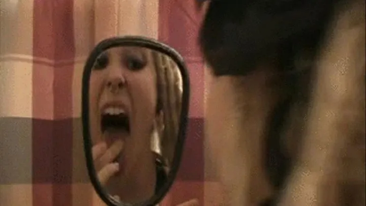 Lona examines her wide open mouth, teeth, tongue, and throat in a hand mirror *** ***