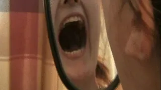 Natalie examines the inside of her mouth in a hand mirror *** ***