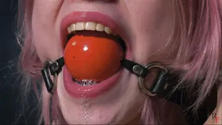 Astrid is tied on a chair and drools through ballgag