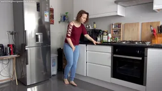 Monika wets her jeans in the kitchen