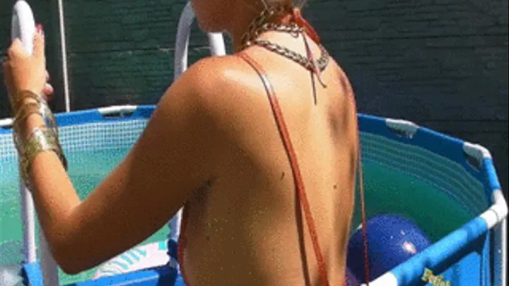 Christina bathing in micro bikini in a pool