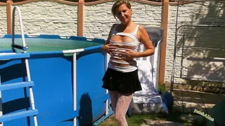 In T-Shirt, Mini skirt and pantyhose in a pool