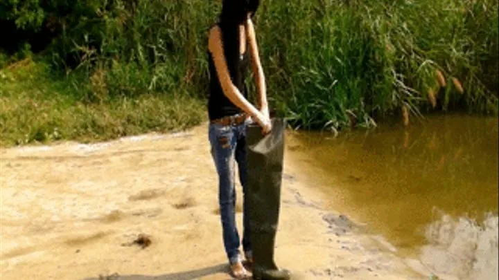 Lena outdoors in Waders walks in a river