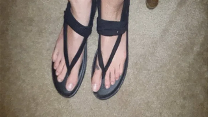 Toe scrunching in black sandals