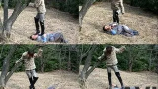 Domme in boots stands up on man's body in the woods - Full version (Faster Download - )