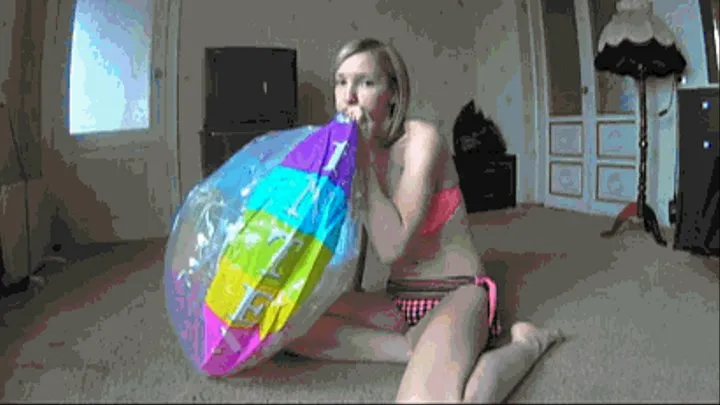 Inflate huge beach ball and ride on it