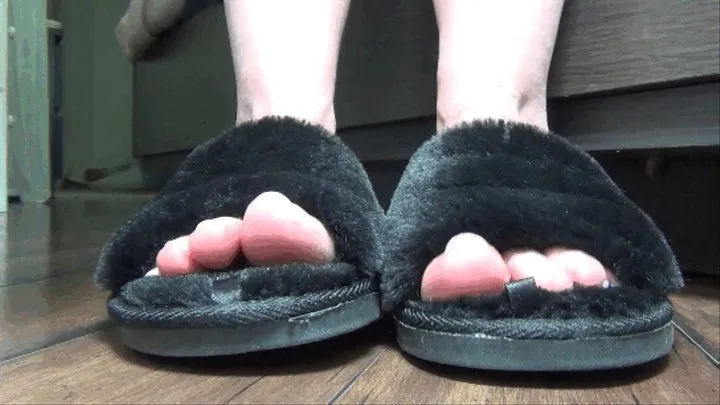 Toe wiggling in plush black slippers 2 TS