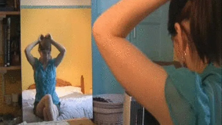 Natalie dances in front of mirror in blue chiffon top and grey shorts