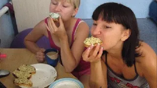 sexy ladys eating sandwiches close to the camera/m