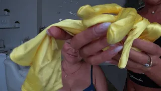 Yellow silk gloves on the neck and around the mouth of a blonde woman aT