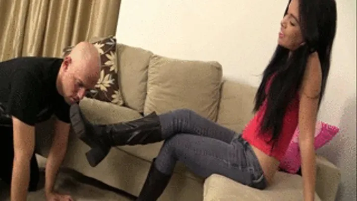 Miss Tiffany enjoys dangling her boots to tease her slave who is on all fours begging to lick on his Mistress's boots