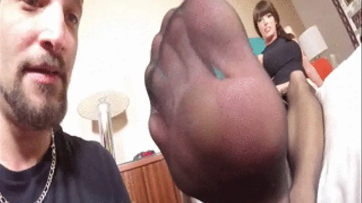 Mistress Bella teases her slave with flexing her stockings feet at his nose