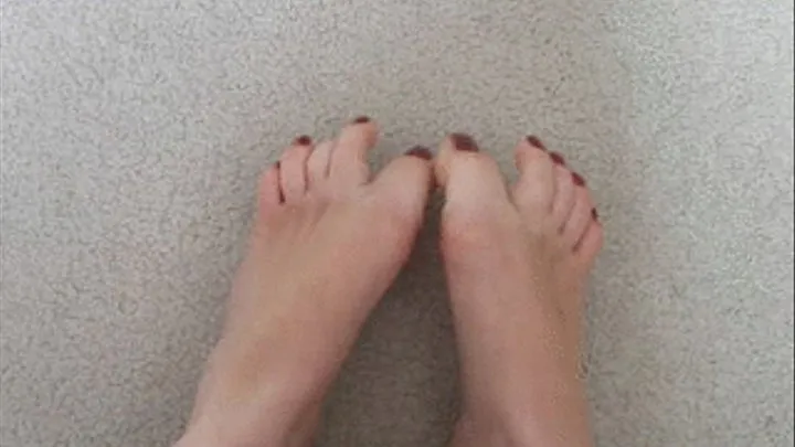 Wiggling my dark red painted toes