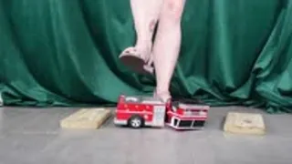 Toy Car Ambulance Crushed by Feet in Purple Sandals and Strong Calves