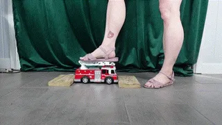 Toy Car Ambulance Crushed by Feet in Purple Sandals and Strong Calves