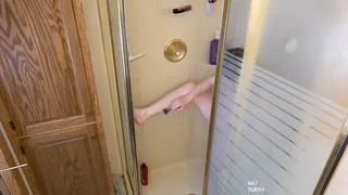 Woman shaving her body in the shower