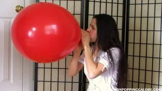 Hannah blows up a 24 inch balloon