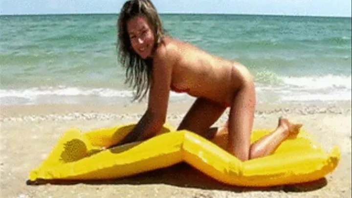 Maggie in Microbikini deflates mattress on beach