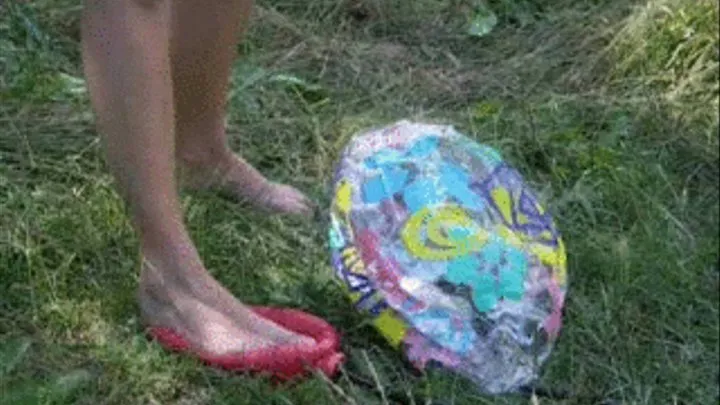 Alina barefeet inflating beachball outdoors