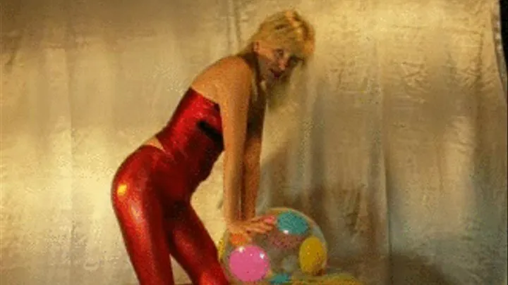 Alina rides beachball in red leggins