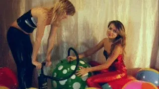 2 girls in Spandex playing with beachballs