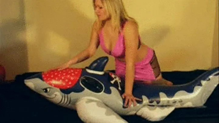 Christina in pink PVC riding a shark