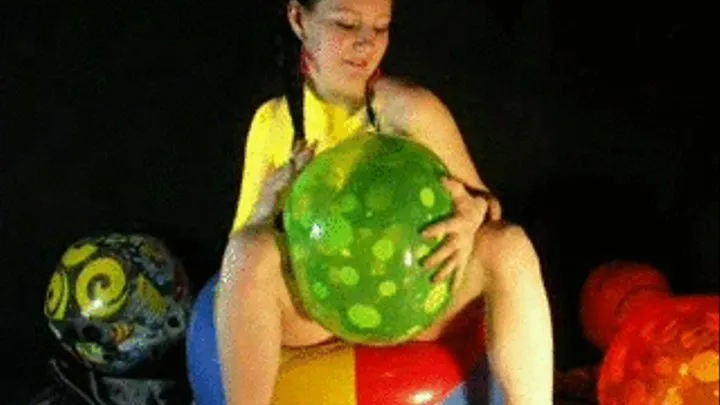 Jackie oils her body on a beachball