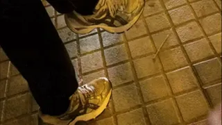 Spanish sneakers lady sitting at the bus stop by night