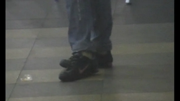 Black Nike sneakers in a mall