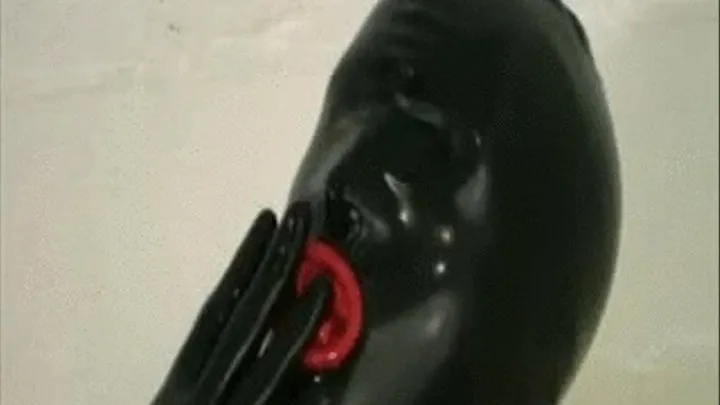 Latex slave blow job