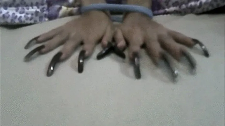 Sexy dark brown nails tied in bed..