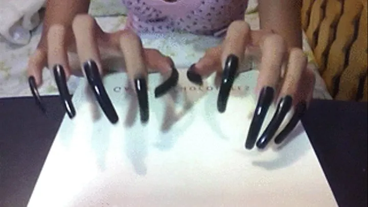 Sexy long black nails tapping in the box..