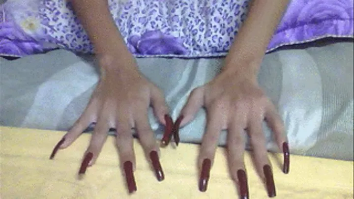 Dark red nails in flat surface