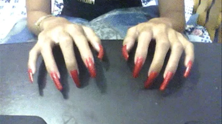 Glittery red nails tapping