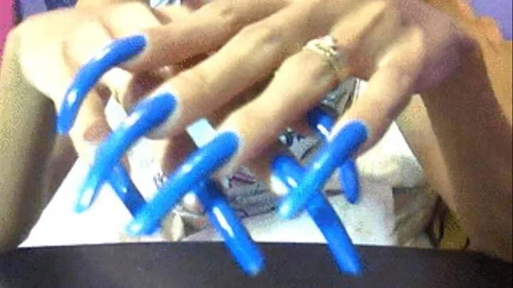 Neon blue long nails close up..