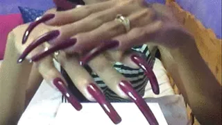 Long dark purple nails close up..