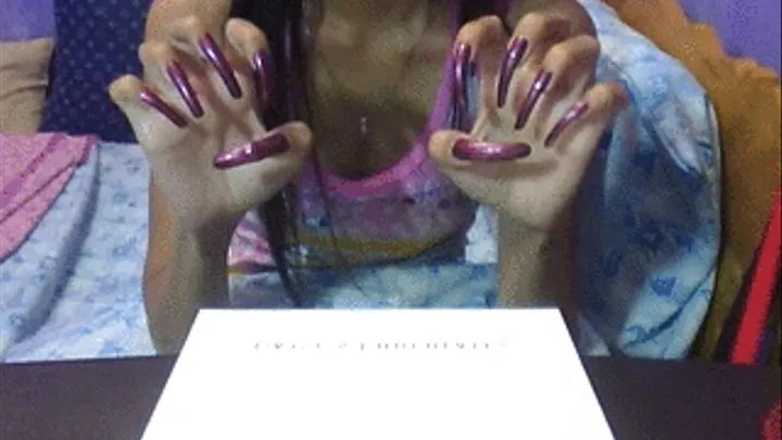 Plum brown nails scratching air..