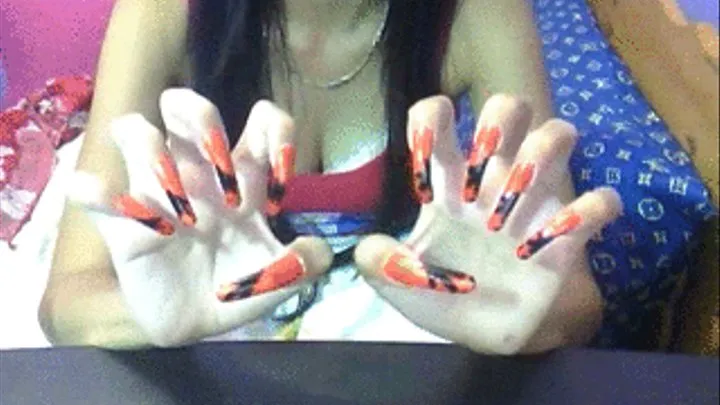 Orange with black design nails air scratching..