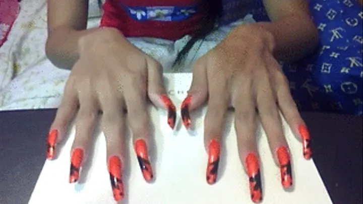 Orange with black design nails in box..