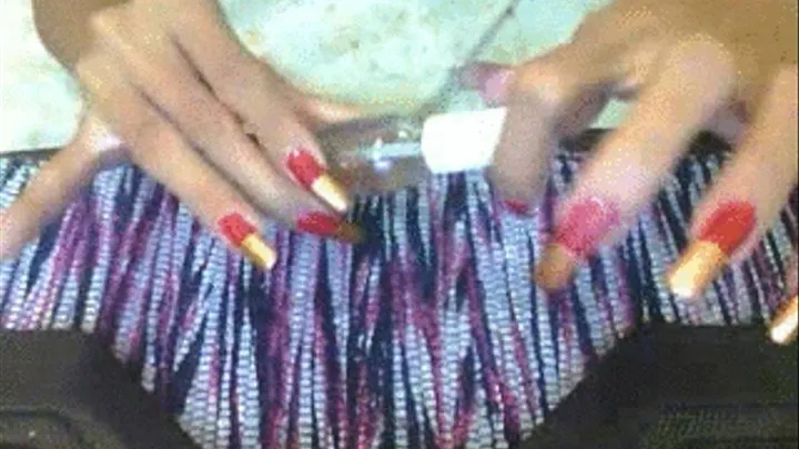 Red and bronze nails applying clear polish